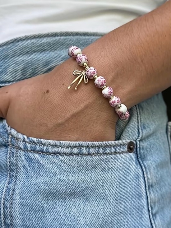 Jewelry - Delicate Pink Floral Bead Bracelet with Gold Bow Charm